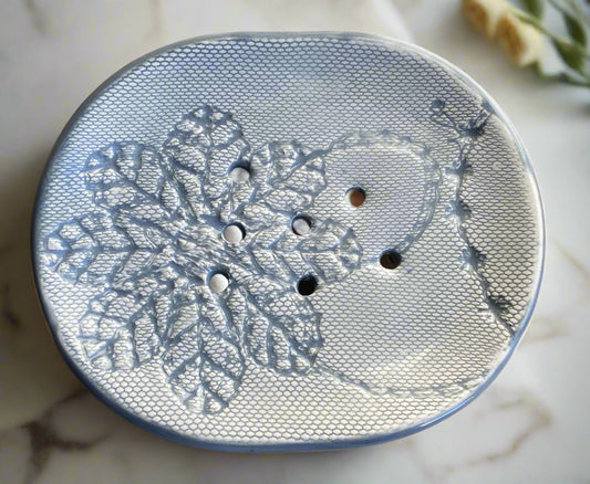handmade ceramic oval soap dish with drainage holes glazed in grey and with crochet pattern