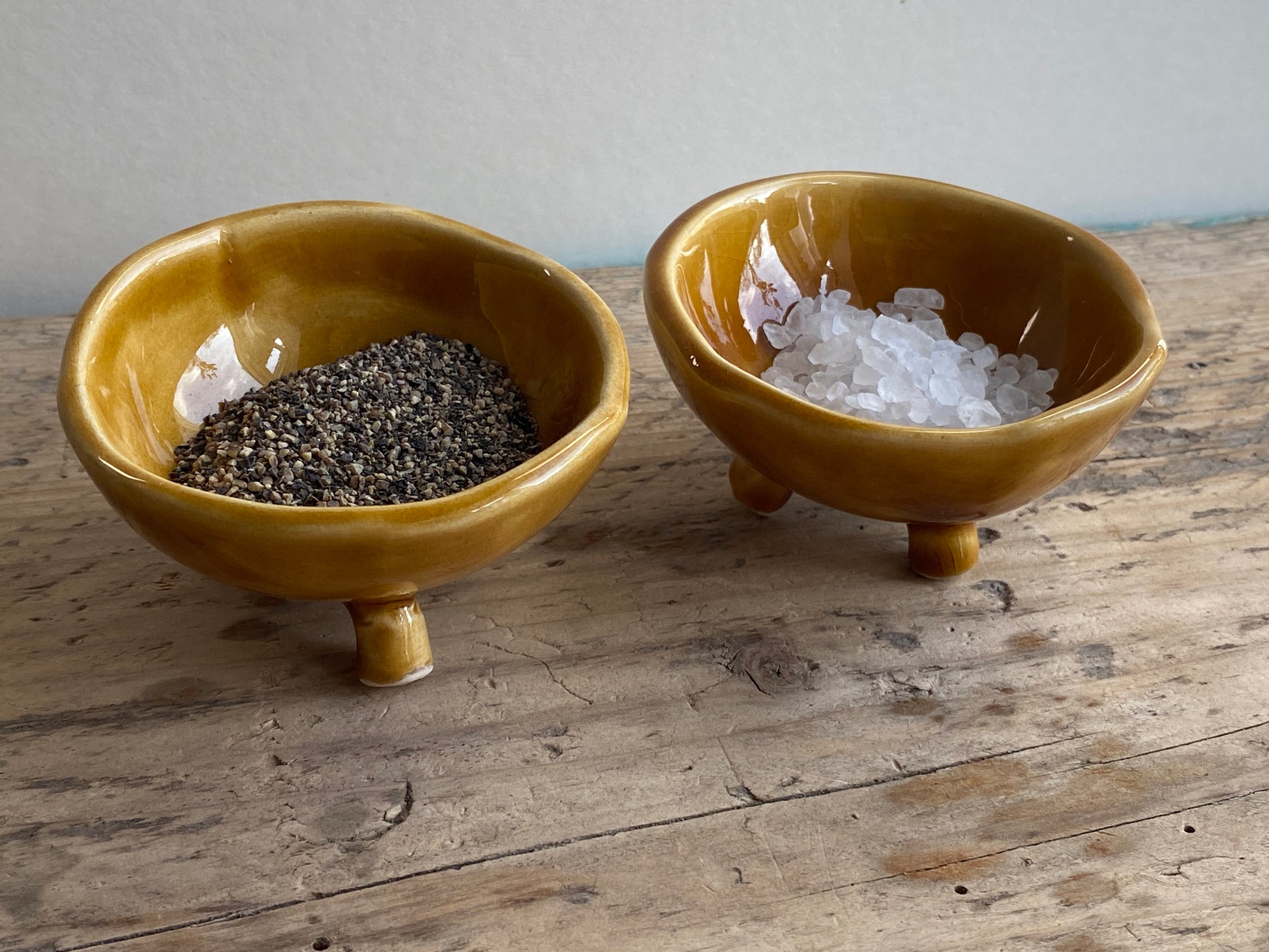 Two small handmade ceramic seasoning bowls. Glazed in rich honey.