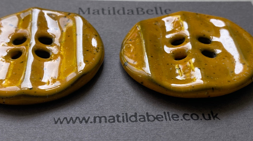 Pair of Extra Large Rippled Black Clay Buttons - 49mm - Yolky Yellow Glaze