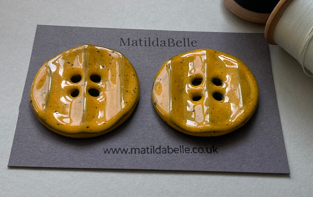 Pair of Extra Large Rippled Black Clay Buttons - 49mm - Yolky Yellow Glaze