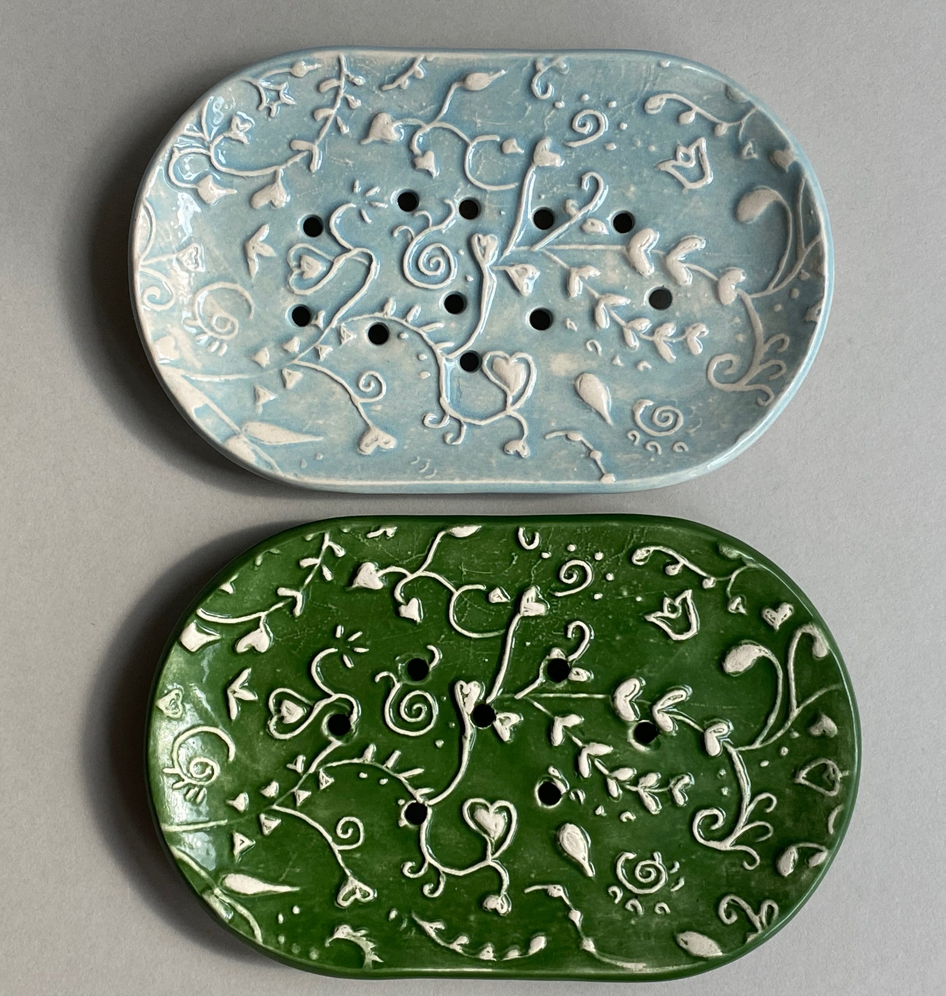 Choice of two handmade ceramic soap dishes with drain holes. Choice of forest green or baby blue in whimsical botanical pattern