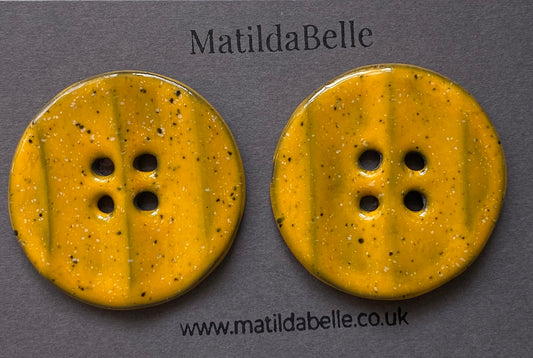 Pair of Extra Large Rippled Black Clay Buttons - 49mm - Yolky Yellow Glaze